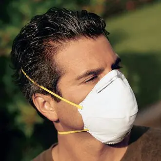 A man wearing NS Respiratory Protection 7210 N95 Disposable Respirator Masks 20/box.
