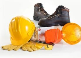 A pair of work boots and hard hats on top of a box.