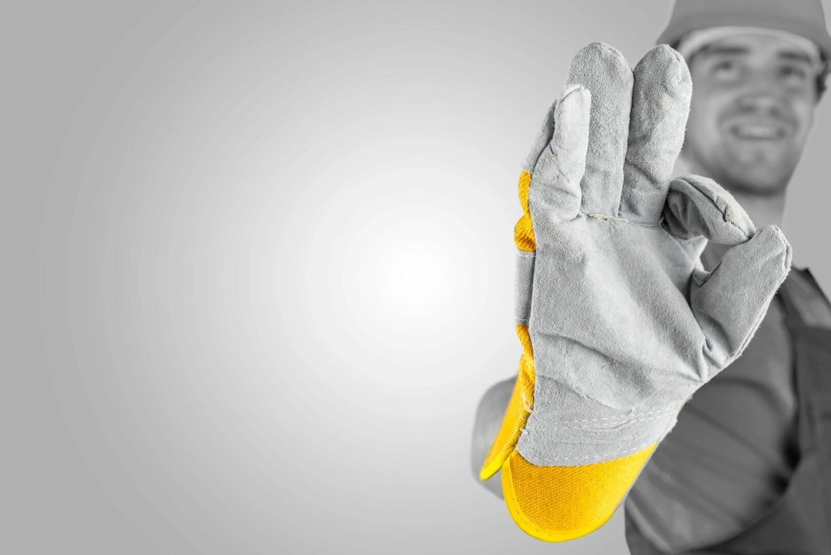 A person wearing gloves holding something in their hand.