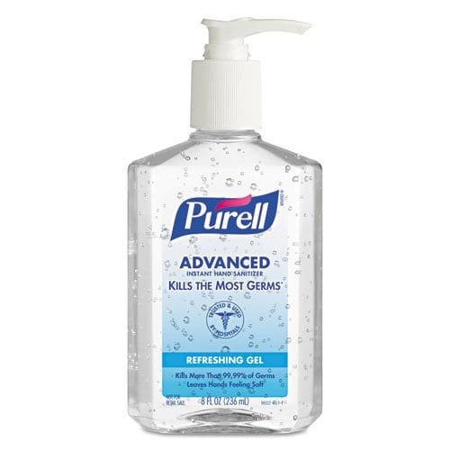A bottle of purell hand sanitizer on a white surface.